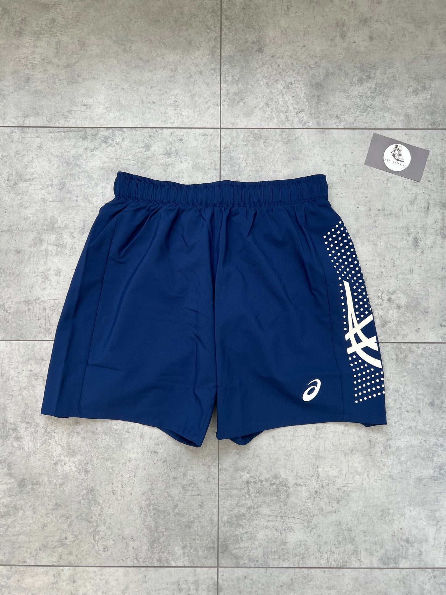 ASICS ‘Midnight Navy’ Icon Shorts featuring white logo branding and dotted graphic detail on the side panel.